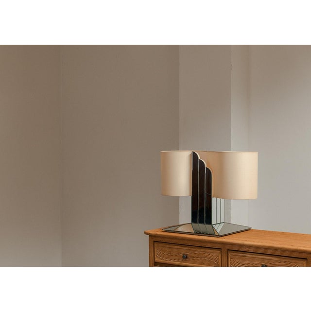 Large table lamp produced in Italy around 1970. Hollywood regency lamp with a playful mirror glass base and a twisted...