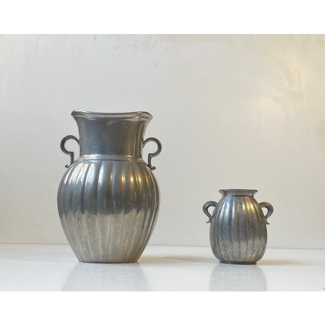 Amphora-style pewter vases with vertical ribbings. Designed and manufactured by Just Andersen in Denmark during the 1940s....