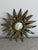 Antique lead sunburst mirror in the style of Line Vautrin, attributed to her student, the artist Irena Jaworska. A refined...