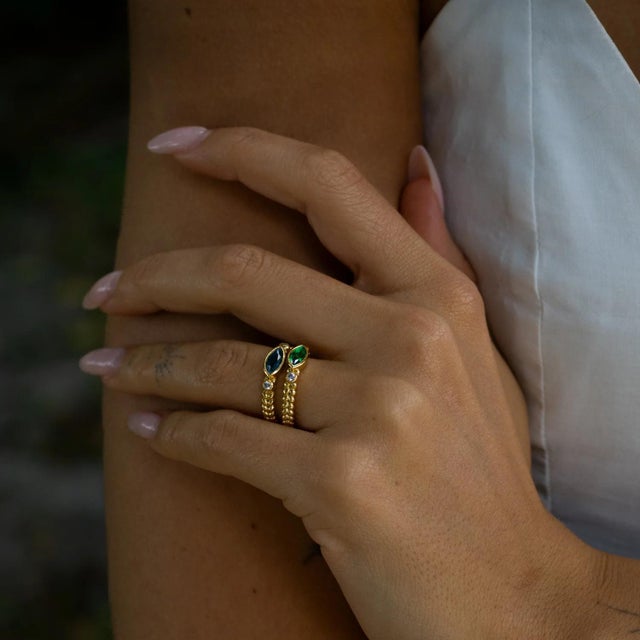 Add a touch of timeless charm with this Emerald Teardrop Gemstone Adjustable Gold Ring. The marquise cut emerald green...