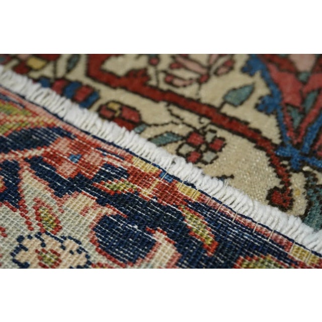 A small central rosette radiates eight bold navy palmette pendants and two additional floriated escutcheon pendants, in a...