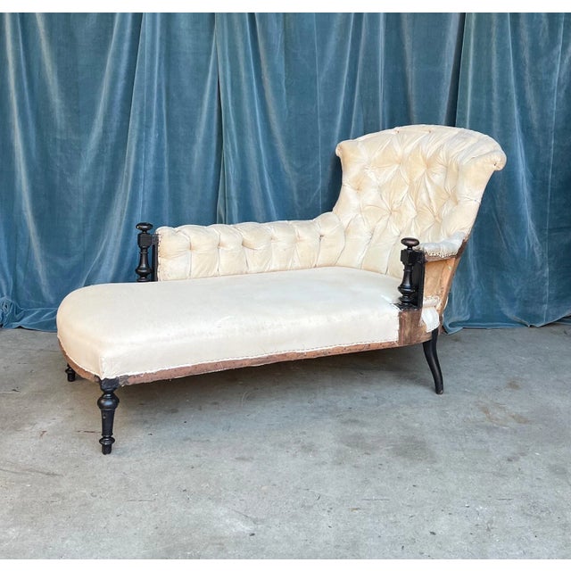 Classic French 19th century Napoleon III tufted chaise lounge with exposed wooden details on the arms. The chaise has been...