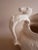 Equestrian theme pitcher. Riding scene embossed on body with decorative horse-head pitcher. Cream glaze with soft crackle....