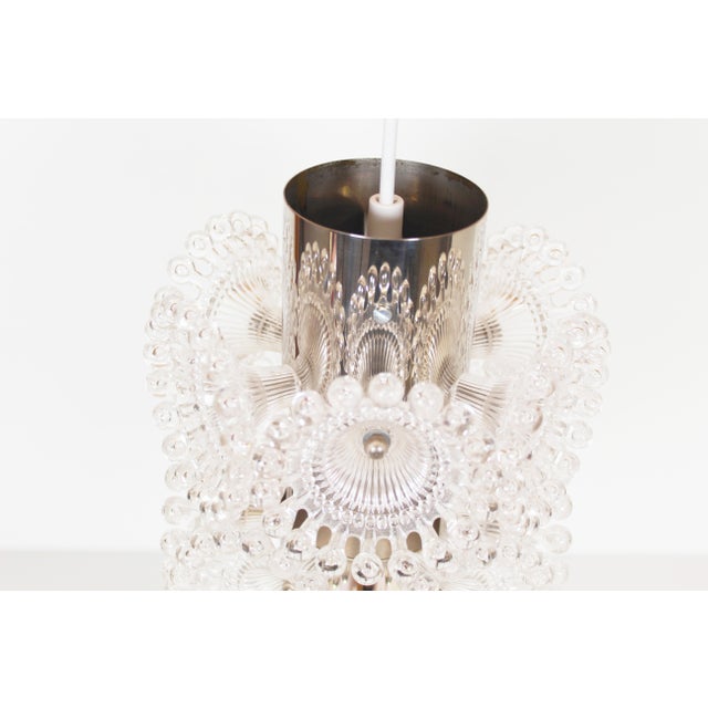 Playful pendant lamp by the German company Solken Leuchten. Chrome metal frame surrounded by plexi flowers. In very good...