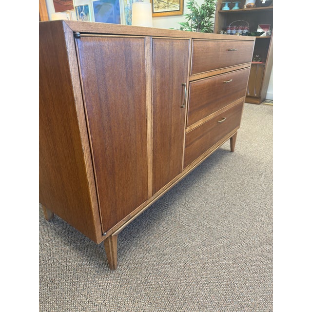 Terrific mid century modern smaller size credenza by Lane Furniture Company. This walnut credenza features a contrasting...