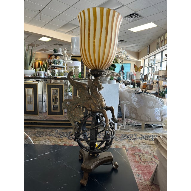 Illuminate your space with this extraordinary Pegasus table lamp, featuring a winged horse poised atop an armillary-...