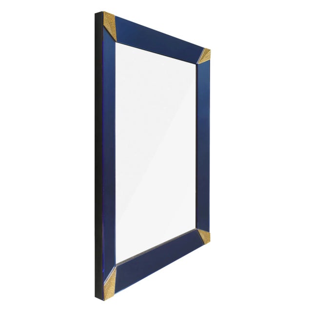 A pair of Murano glass grand mirrors made of blue glass with gold textured triangular corner elements. Can be sold...