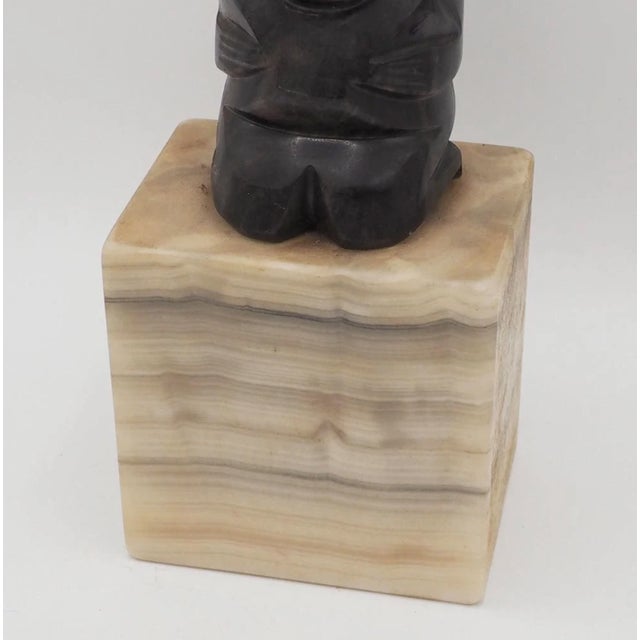 Mid Century Modern hand carved stone sculpture featuring a stylized primitive-inspired human figure mounted on a solid...