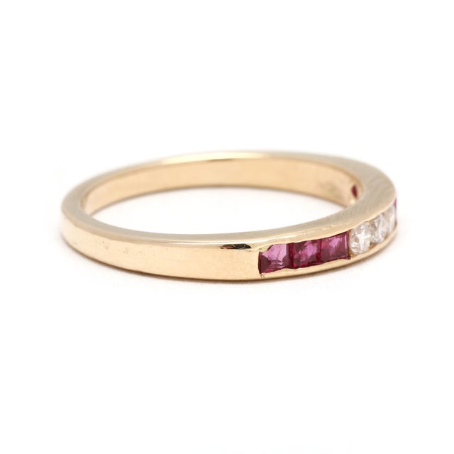 Stones: ruby, 6 square cut 2 mm approximately .30 total carats diamond, 3 round brilliant cut 2 mm approximately .09 total...