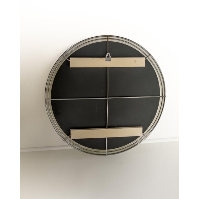 Circular wall mirror with a double tubular chromed metal frame joined by small radial elements. European production,...