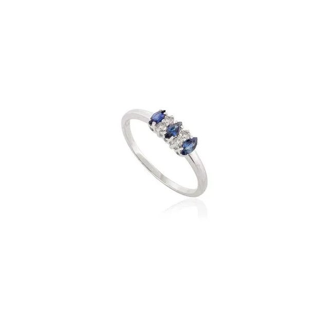 This is part of Chairish’s Fine Jewelry assortment. Dainty Three Stone Fine Blue Sapphire and Diamond Ring in 14K Gold...