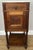 A charming antique French bedside table featuring a beautiful white marble top above a richly grained oak body with carved...