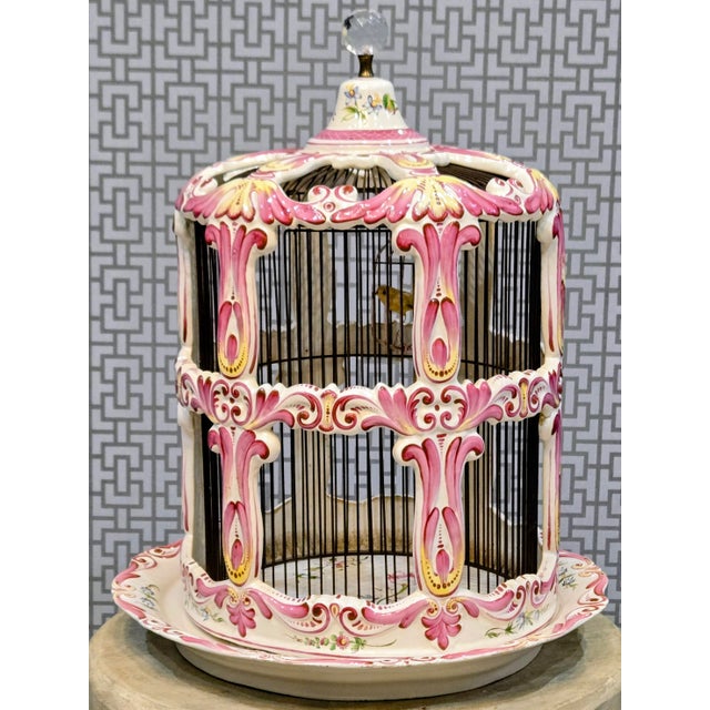 A striking large French Rococo-style hand-painted porcelain bird cage, standing an impressive 20 inches tall. This ornate...