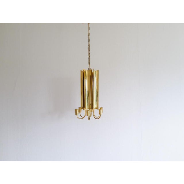 This rare brass chandelier "Reflex" was designed nu Pierre Forssell and produced at Skulltuna Sweden in the 1960s. The...