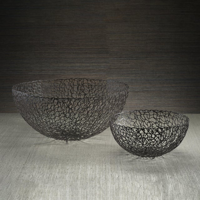 A unique statement piece, this openwork decorative bowl is crafted from wrought iron with a hand-applied rust finish,...