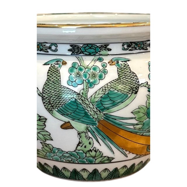 A gorgeous, vintage Gold Imari green and white cachepit. Features a pair of peacocks surrounded by florals on a white...