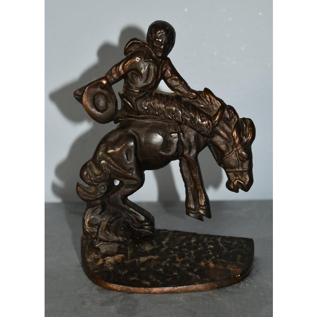Vintage (1930's) Cowboy & Horse Sculpture has a Rustic Style. Made of metal. Bronzed Colored Metal. The Measurements: 5"W...
