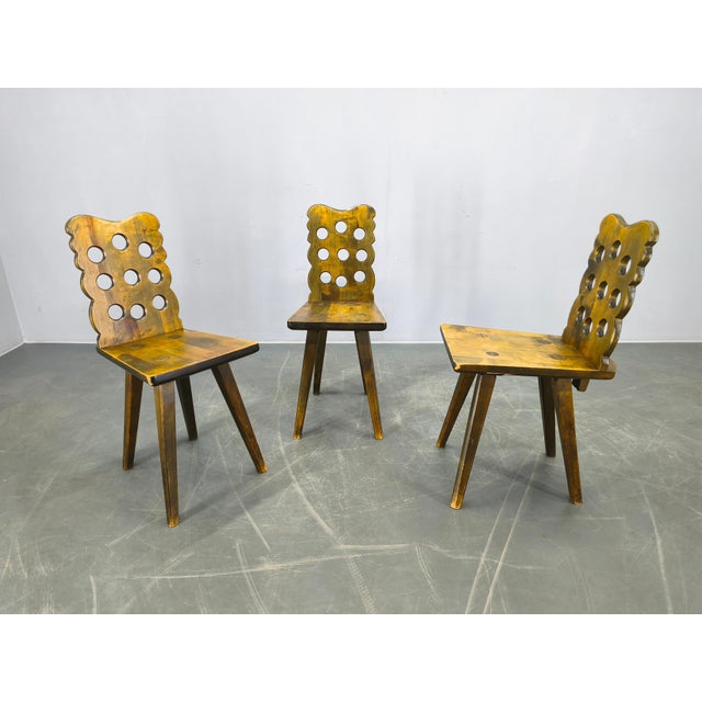 Rare set of three wooden chairs produced in Czechoslovakia during the 1950s. These chairs feature distinctive sculptural...