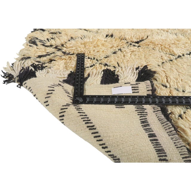 21365 Vintage Moroccan Beni Ourain Rug. 06'02 x 10'05. Emerging from the revered Beni Ourain tribe, a cornerstone of...