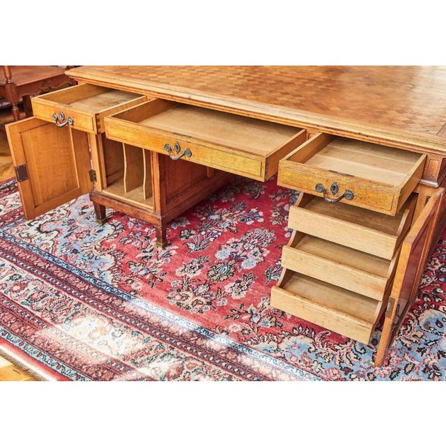 Large and spacious desk made of solid oak with a top decorated with parquetry. This desk made of selected solid oak in...