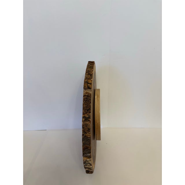 Live edge with bark remaining and concentric ring of the age seen in the tree when it was fell to make this slab of Acacia...