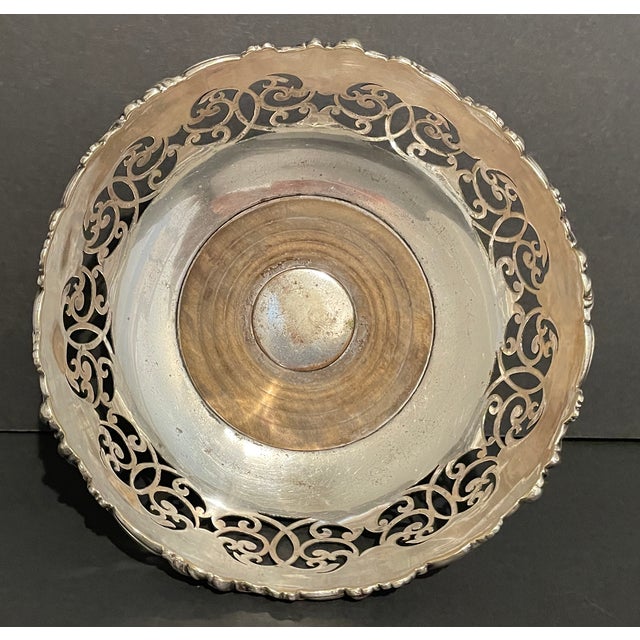 Antique silverplate wine coaster with grape vine and scrolling decoration. The body is more flared than most wine coasters...