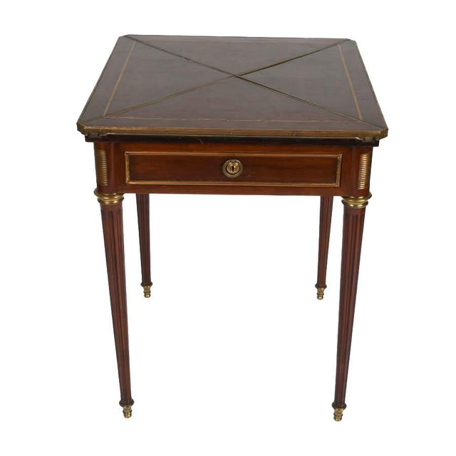 Elegant in proportion and restrained in ornament, this Edwardian mahogany game table reflects the refined craftsmanship...
