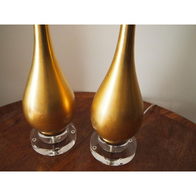 Pair of Mid-Century gilt ceramic lamps on stacked lucite bases. 20.25" to top of socket, 26" to top of harp.