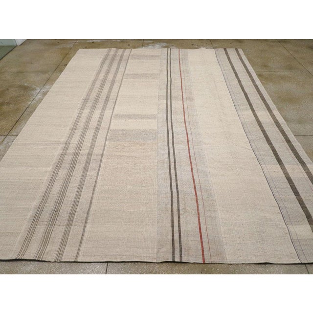 A vintage Turkish flatweave Kilim room size carpet handmade during the mid-20th century. Measures: 10' 8" x 14' 1".
