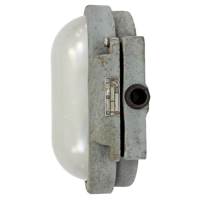 Industrial wall light made by Elektrosvit in former Czechoslovakia during the 1960s. It features a cast iron body and a...