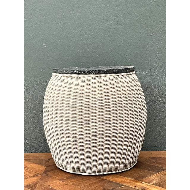 This vintage rattan and wood side table beautifully captures the organic warmth and relaxed sophistication of mid-century...