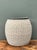 This vintage rattan and wood side table beautifully captures the organic warmth and relaxed sophistication of mid-century...