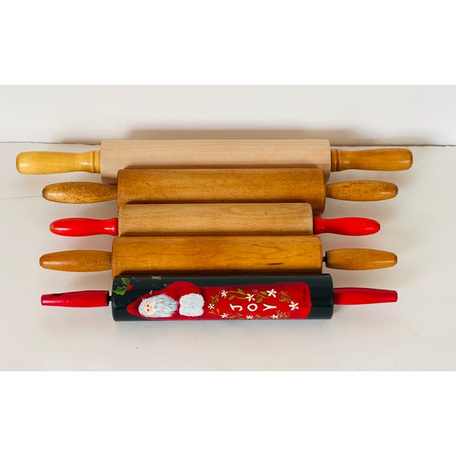Set of 5 vintage maple rolling pins, from 20” to 14”, one is painted with Santa Claus. Kitchen accessories collectible.