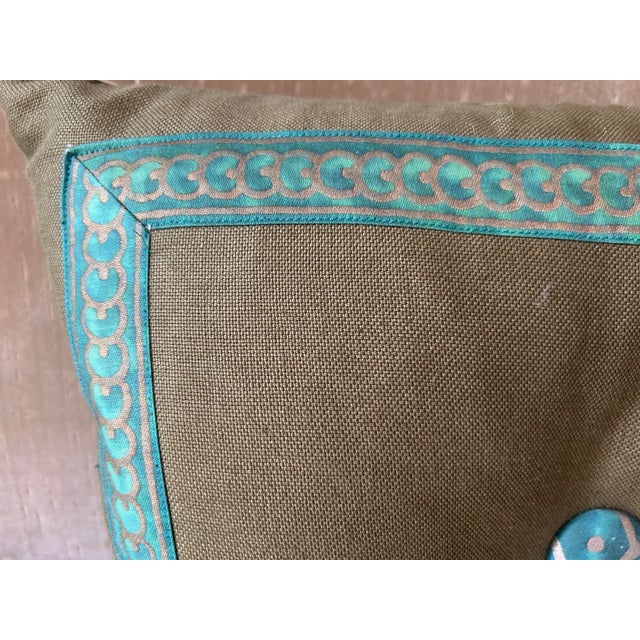 A pillow made with linen and trimmed and tufted with Fortuny’s iconic printed fabric, down inserts are included