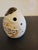 Ceramic sculpture, Asian origin, with a tan to terracotta coloration around some features. Can be used as a flute but...