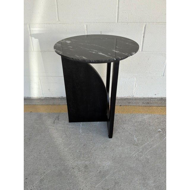 Stylish Ramonawind Black Accent Table. Sculptural wood base with black and white marble top. Showroom floor sample.