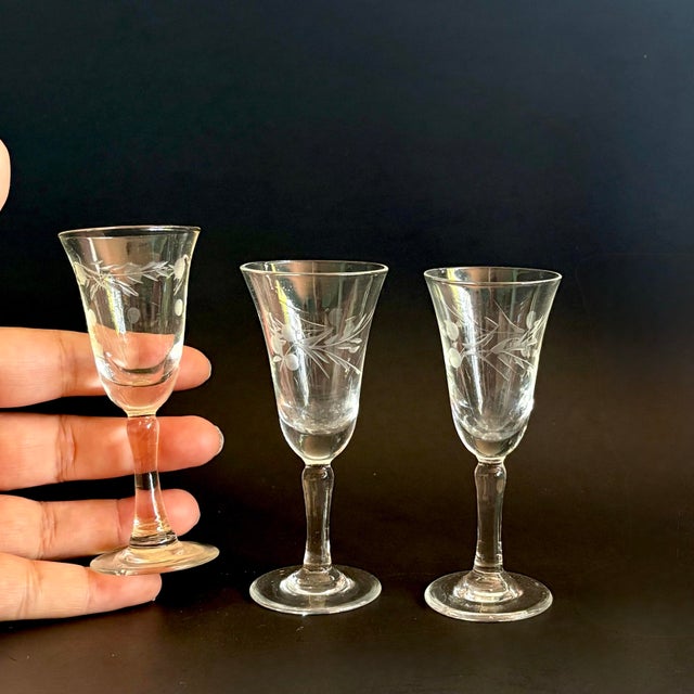 A charming set of 3 vintage cordial glasses, showcasing elegant etched detailing and timeless mid-century styling. These...