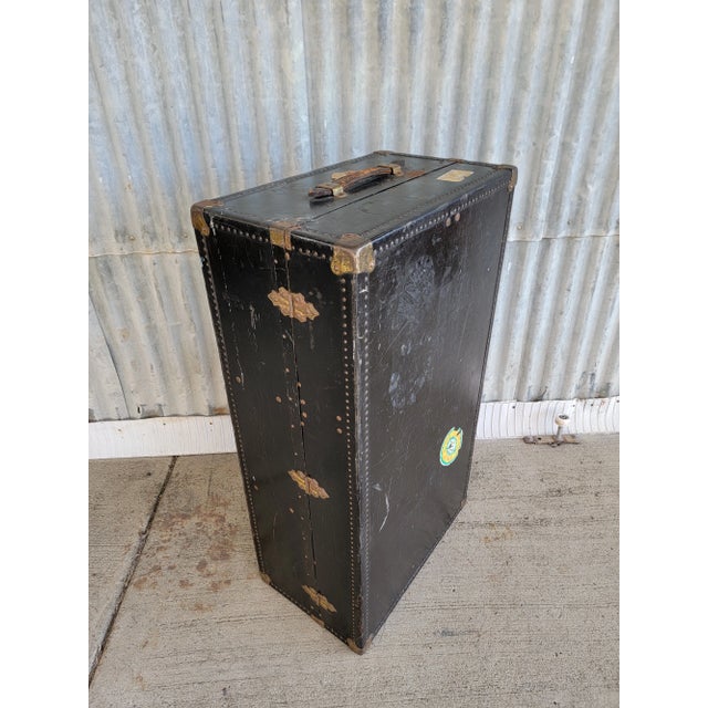 A vintage steamer trunk by Oshkosh Trunks & Luggage Inc. Fitted with 3 removable storage compartments and a section for...