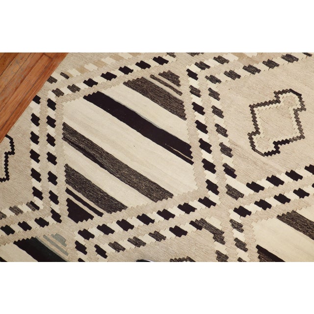 Late 20th-century geometric kilim in brown, ivory and camel tones Measures: 10'1'' x 14'.
