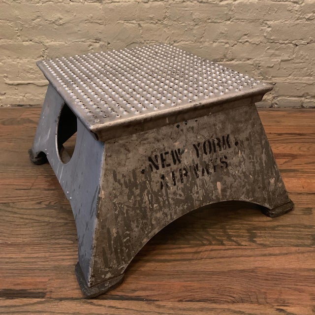 Industrial, aluminum, airplane step stool features the stamp New York Airways, (1949-1968) on one side, a perforated top...