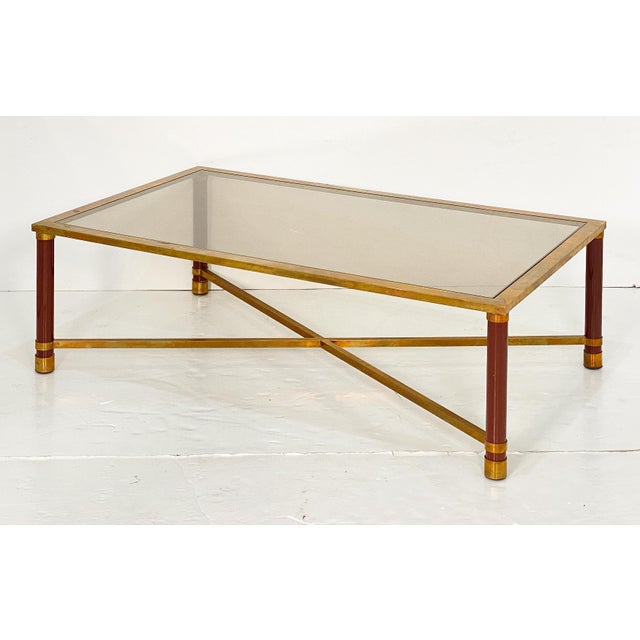 A fine French Modern rectangular cocktail or coffee low table, featuring an elegant brass frame with an inset top of...