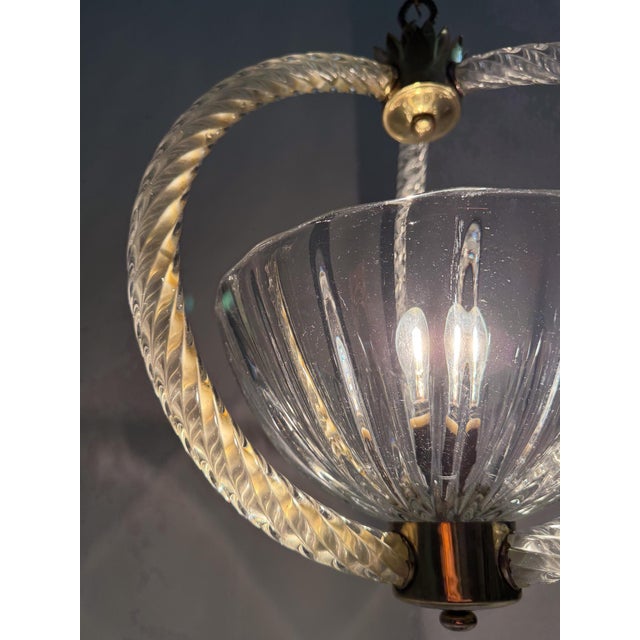 Beautiful and distinctive Italian pendant chandelier from the 1930s, handcrafted in clear Murano glass with brass details....