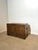 This remarkable wooden storage chest features intricate brass inlay work across the front, top, and corners, forming...