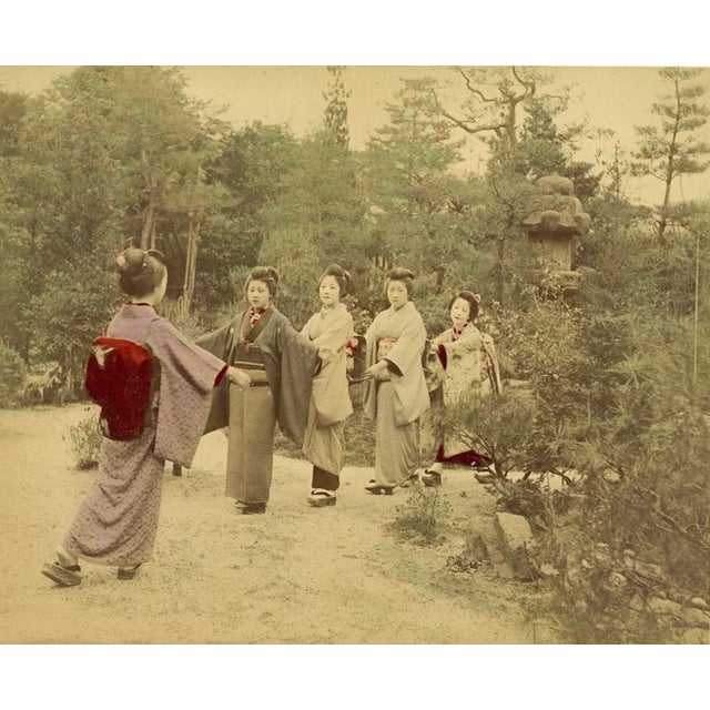 Performing Geishas in a garden is an hand-inked Albumen print with aniline applied on hardcover. Very good conditions....