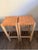 A beautifully pair of bar stools featuring thick, handwoven natural tan leather seats over solid oak frames in a light...