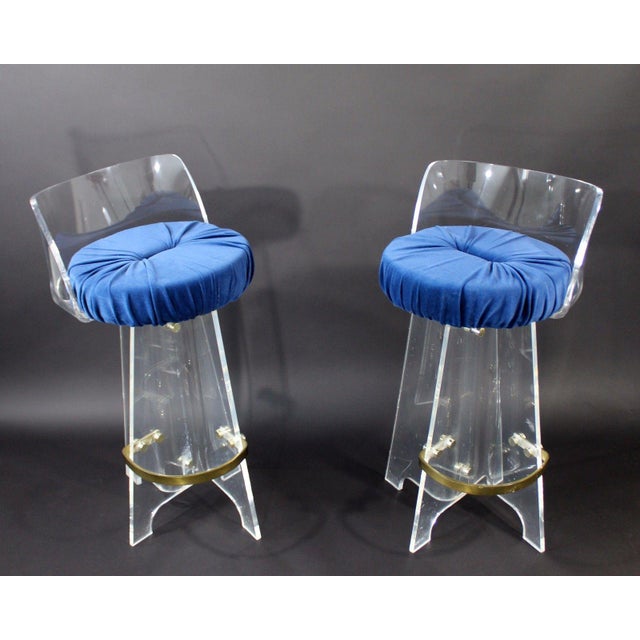 For your consideration is an absolutely fabulous pair of lucite and brass, swivel bar stools, with a deep, blue velvet...