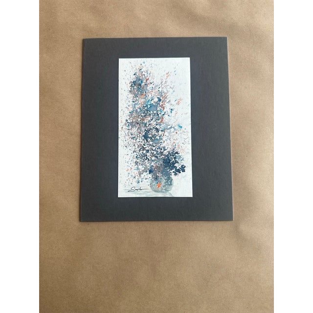 An expressive abstract watercolor capturing the airy movement of florals in a glass vessel. Delicate splatters and layered...