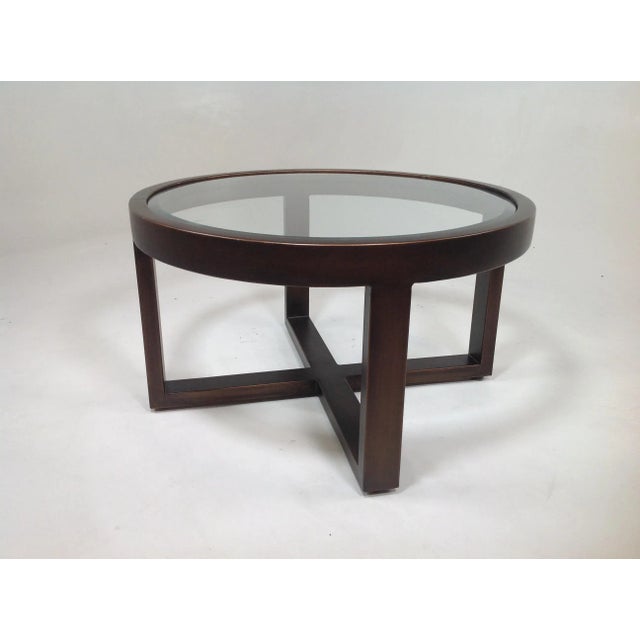 Modern round coffee table. Table has a copper finish with glass inset. The table is made of iron. Coffee table has a...