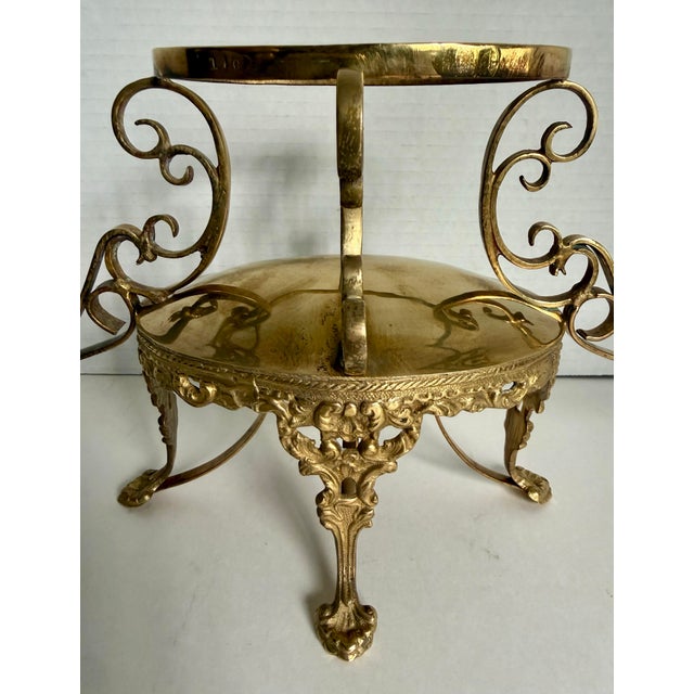 This elegant French Revival brass epergne centerpiece features three scalloped removable bowls supported by an ornate...