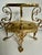 This elegant French Revival brass epergne centerpiece features three scalloped removable bowls supported by an ornate...